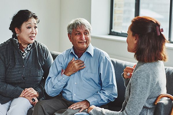 A patient with a chaperone speaking to a medical professional